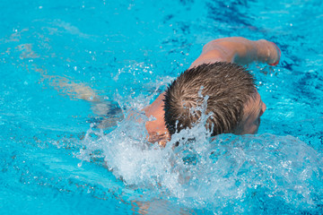 Man swims in the pool. 