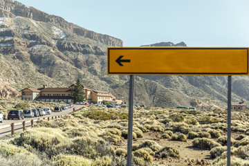 View of an outdoor parking and a building in the middle of a rocky area