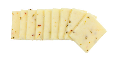 Top view of a small group of fresh pepper jack cheese squares in a row isolated on a white background.