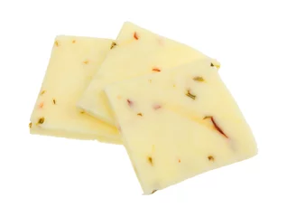  Three squares of fresh pepper jack cheese isolated on a white background. © Bert Folsom