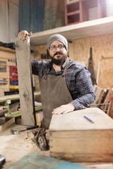 Wood designer working in workshop.