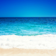 Fototapeta na wymiar Sea Beach and Soft wave of blue ocean. Summer day and sandy beach background.