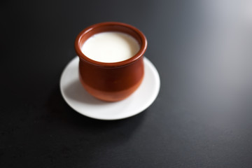 Sour  cream or natural  Cottage cheese curd  in traditional ceramic bowl on dark  background. Traditional Cuajada yogurt cream