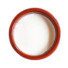 Sour  cream or  Cottage cheese curd in clay pot  isolated on a white background. Traditional Cuajada yogurt cream close up.