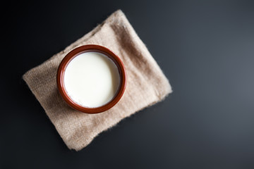 Sour  cream or natural  Cottage cheese curd  in traditional ceramic bowl on dark  background....