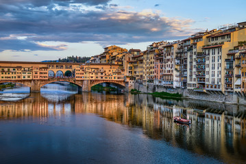 Fototapeta na wymiar Florence cityscape view with Ponte Vecchio, a medieval stone bridge over Arno River.