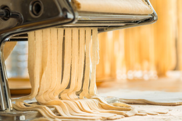 Making traditional Italian pasta or noodles.Handmade Italian fresh pasta background text space.