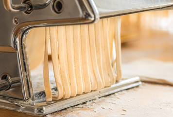 Making traditional Italian pasta or noodles.Handmade Italian fresh pasta background text space.
