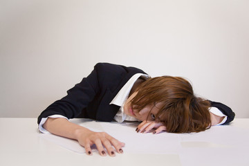 Tired Japanese Office Worker at Workplace