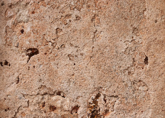 Textures of weathered stone wall background of the ancient city.