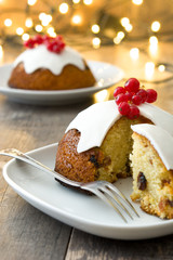 Christmas pudding and christmas light on wooden table
