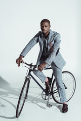 Stylish man riding bicycle