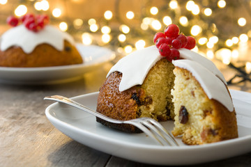 Christmas pudding and christmas light on wooden table

