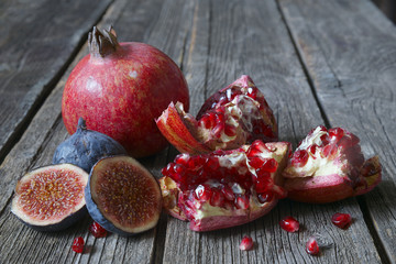 Fruits of pomegranate and figs on a rustic background in natural light.