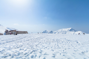  The snow mountains of Tateyama Kurobe alpine  with blue sky  background is  one of the most important and popular natural place in Toyama Prefecture, Japan.