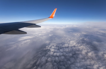 Obraz premium Flight over mountains and clouds, view from the plane