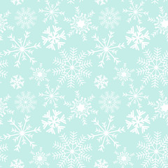Seamless snowflake Christmas pattern on a blue background.