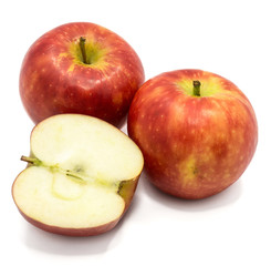 Red Kanzi apples, two whole, one half, isolated on white background