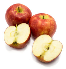 Red Kanzi apples, two whole, two halves, isolated on white background