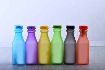 Row of colorful soft drinks on grey background background