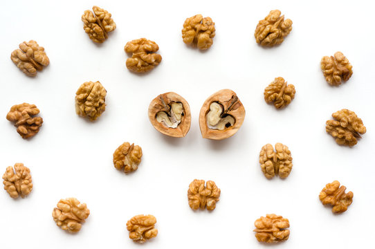 Walnut pattern backdrop. Open nuts with kernel on white background. Top view. 