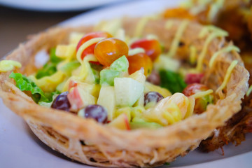 Fruit salad cream in taro basket