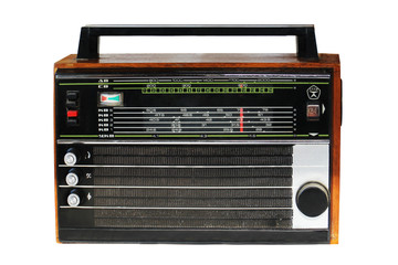 An old transistor radio portable model in a wooden case. Made in USSR. Most popular in the 70-80s. Isolated on white. letters on the left indicate the wavelengths long, medium, short, ultra short