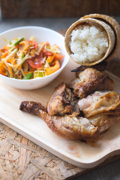 Grill chicken and sticky rice served with spicy papaya salad