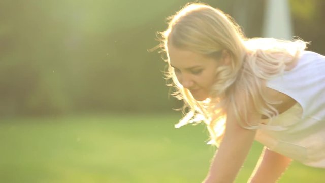 girl cleans grass rake