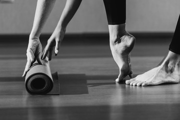Fototapeta na wymiar woman rolling out yoga mat