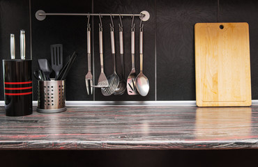 Black kitchen with kitchen utensils