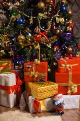 Fototapeta na wymiar Decorations and gifts on Christmas tree