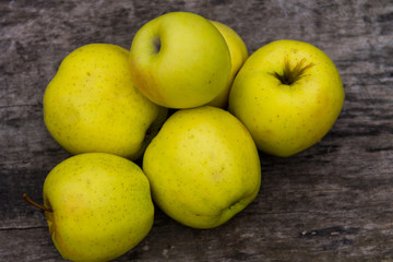 Ripe green apples on rustic wooden table