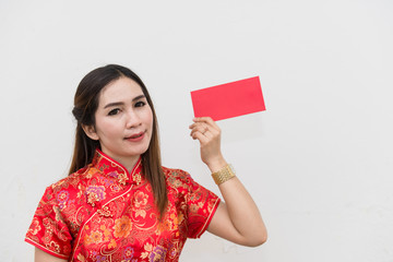 happy Chinese new year. Portrait of Asian woman has red envelope on white wall
