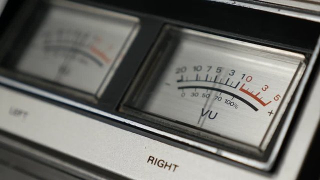 Needles of standard volume level indicator close-up footage - Analog VU meter scale shallow DOF