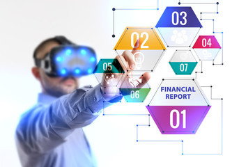 Business, Technology, Internet and network concept. Young businessman working in virtual reality glasses sees the inscription: Financial report