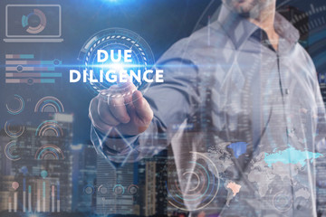 Business, Technology, Internet and network concept. Young businessman working on a virtual screen of the future and sees the inscription: Due diligence
