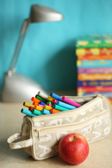 Education accessories with pens. lamp and apple