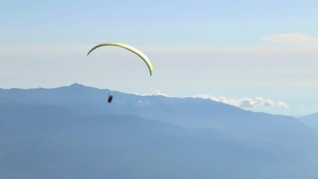 Following Parachute silhouette the mountains