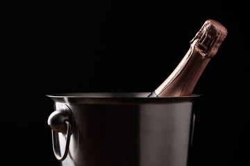 Photo of bottle of champagne in iron bucket