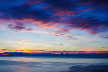 Beautiful red sunset over the lake with mountain