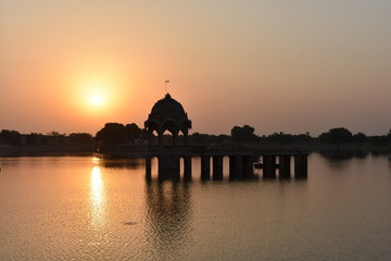 historical monument with sunrise in gadisar lake jaisalmer rajasthan india