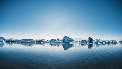 Beatufil vibrant picture of icelandic glacier and glacier lagoon with water and ice in cold blue tones, Iceland, Glacier Bay - obrazy, fototapety, plakaty