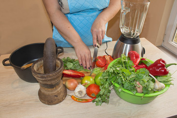 Chef cuts the vegetables into a meal. woman hands cutting vegetables on kitchen blackboard. Woman preparing vegetables