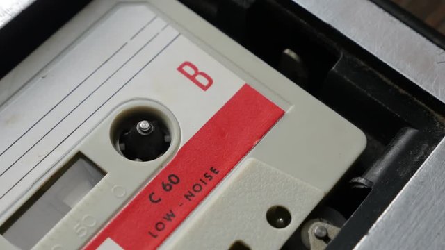 Old music archives playing from cassette in casettophone footage - Audio tape player supply spindle
