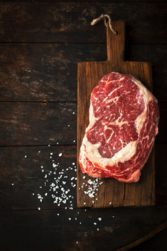 Raw fresh ribeye steak with salt
