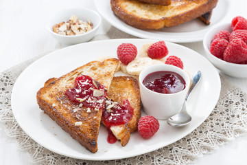 sweet breakfast - toasts with raspberries, banana and jam
