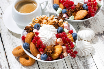 sweet breakfast with cookies, marshmallow and berries, top view
