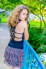 girl with photo camera posing on bridge