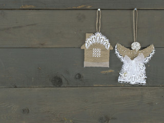 New Year handmade toys hung on a wooden background. 